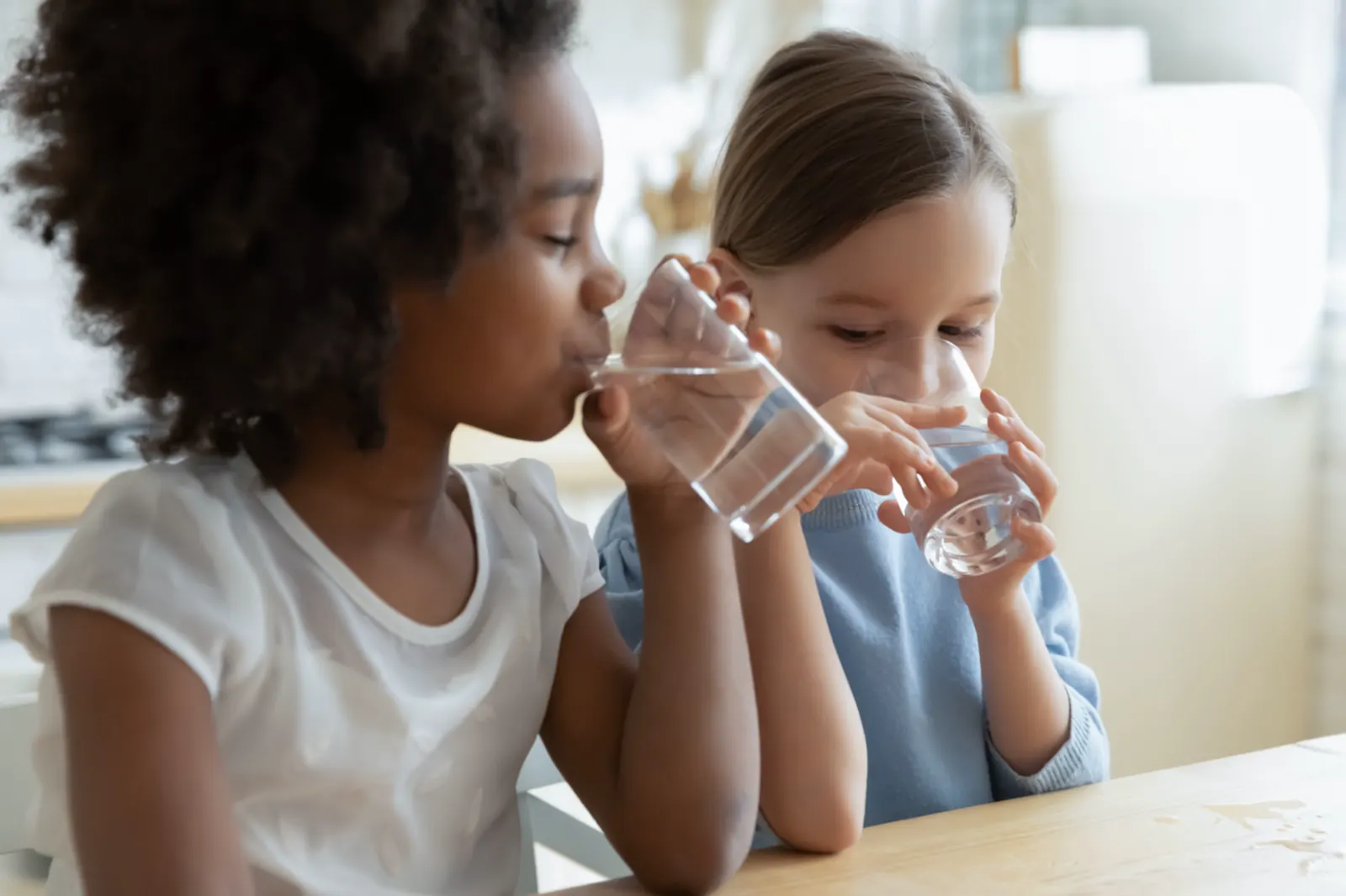 Children drinking clean water at home